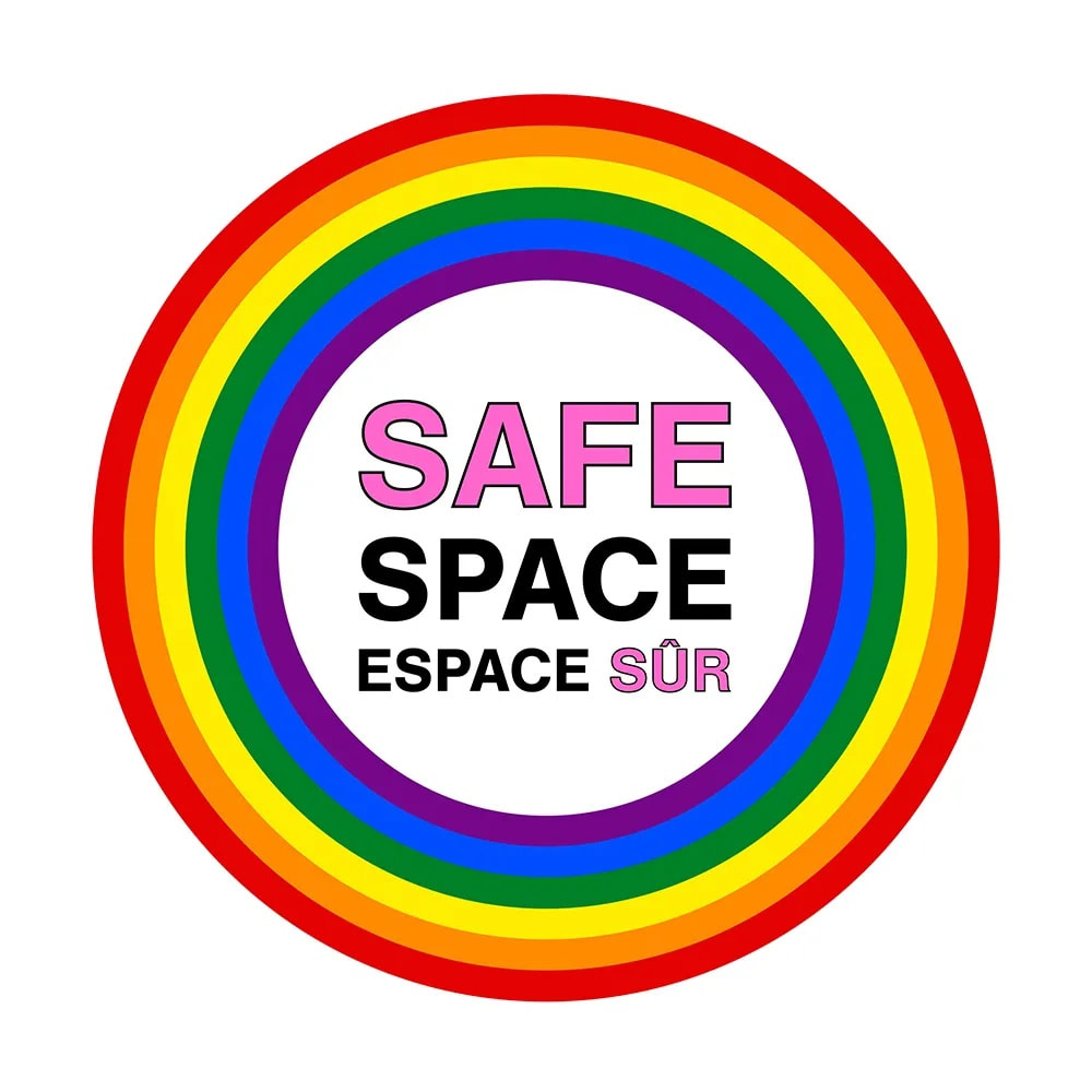 A circle with the color of rainbow and the phrase Safe Space Alliance in the centre